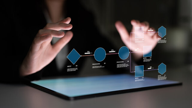 Futuristic Businessman Using Touchscreen Interface to Display Data and Analytics in a Dark Environment with Glowing Graphs and Icons Quark.