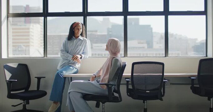 African American women coworkers after headband prompt exchanging ideas at counter with grid window