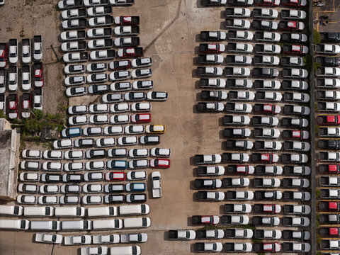 Aerial view of a large parking lot filled with rows of pickup trucks parked in an organized industrial storage area in Santo Domingo, Distrito Nacional, Dominican Republic.