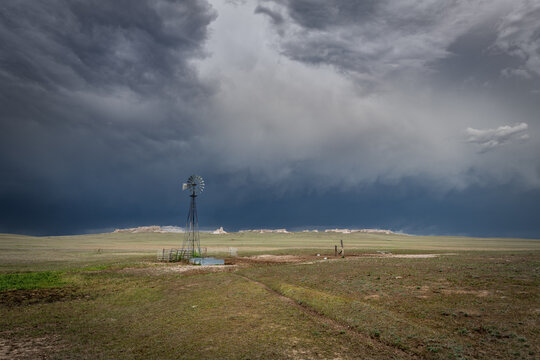 Rustic old farming windmill in stormy weather
