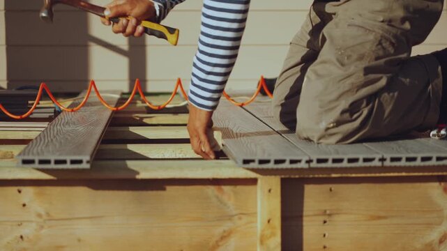 Installation of decking boards, floor installation, house construction