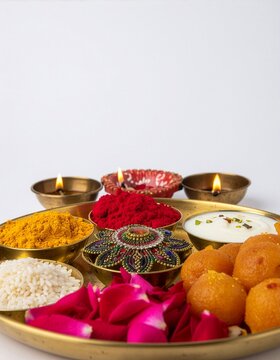 Diwali Puja Thali With Diyas, Sweets, Turmeric Powder, Colored Holi Powders and Rose Petals