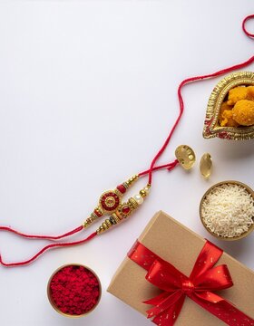 Rakhi and Gift Box With Traditional Sweets and Puja Items for Raksha Bandhan Celebration