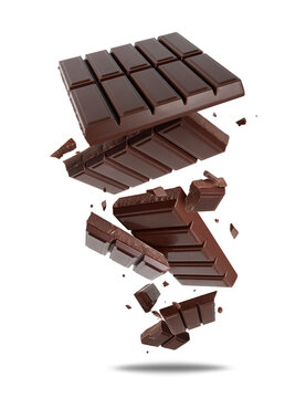 Broken dark chocolate bar pieces scattered in the air with chocolate crumbs