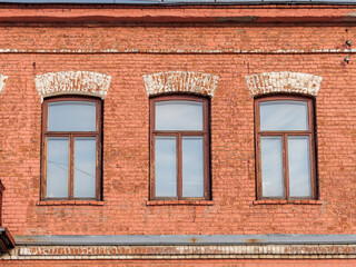 Three windows of the old mansion 19 century with brown bricks wall © Dmitrii Potashkin