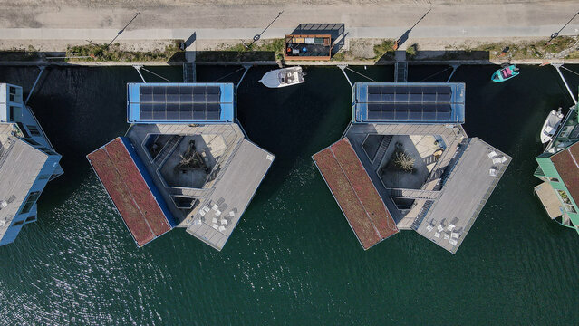 Aerial view of the Urban Rigger floating student housing complex featuring modular containers, solar panels, and central courtyards on the water in Kobenhavn, Kobenhavn, Denmark.