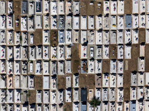 Aerial view of the cemetery with rows of rectangular graves and tombstones in Evora, Evora District, Portugal.