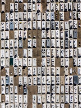 Aerial view of the cemetery with rows of white stone tombs and floral tributes in Evora, Evora District, Portugal.