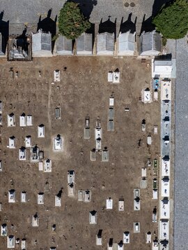 Aerial view of the historic cemetery in Evora featuring rows of stone graves, pathways, and trees in Evora, Evora District, Portugal.