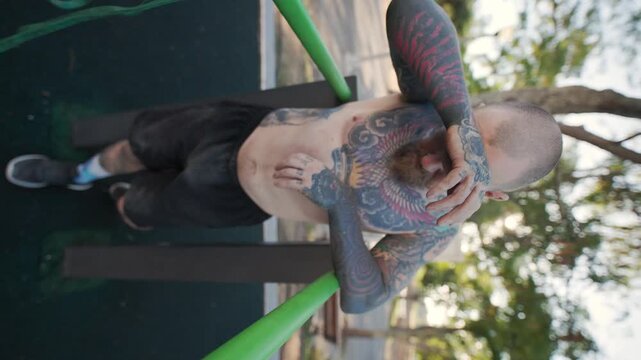 Tattooed athlete performing an intense outdoor workout