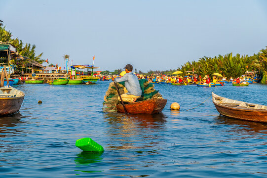 A view of an assortment of boats on the waterways of the Bay Mau coconut forest in Cam Thanh village near Hoi An, Vietnam on a bright sunny day