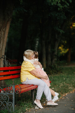 Grandmother embracing granddaughter sharing love in park