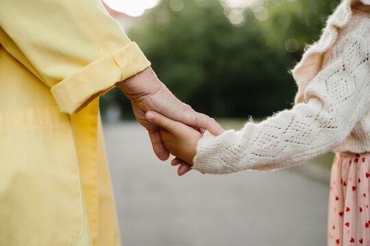 Grandmother and granddaughter holding hands showing family love