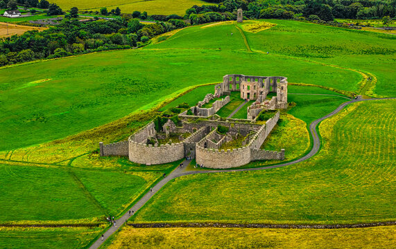 Aerial view of the historic ruins of Downhill House surrounded by vibrant green fields and rolling hills in the countryside, Coleraine, Causeway Coast and Gl, United Kingdom.