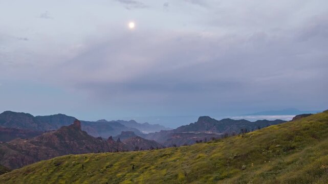 Night to day hyper lapse of moonlight on Roque Bentayga and volcanic caldera of Tejeda, Gran Canaria, Canary islands, Spain.