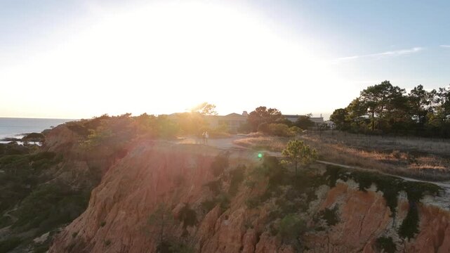 Falesia Beach, Algarve, Portugal. Golden mile beach with orange rocks, golden sand and turquoise sea. Aerial drone top view perspective. Famous travel destination in south of Portugal 
