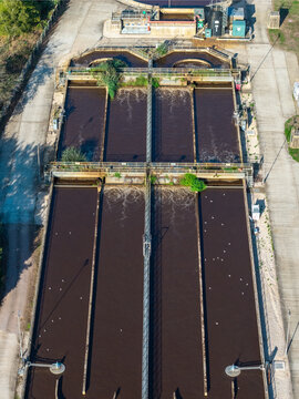 Farnham, United Kingdom - 15 September 2026: Aerial view of the Waste Water Treatment Works featuring large aeration tanks, industrial infrastructure, and concrete walkways.