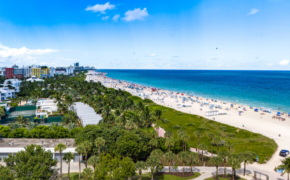 Miami Beach, Florida, United States - 21 September 2024: Aerial view of South Beach with its sandy coastline, turquoise ocean, and lush palm trees under a bright blue sky.