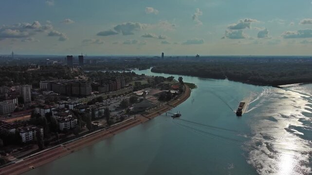 Aerial view of Belgrade at confluence of Sava and Danube rivers. Urban landscape, forested river island and city view, 4k