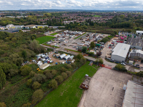 Stafford, United Kingdom - 13 September 2026: Aerial view of the Bostik industrial site featuring warehouse buildings, a caravan park, surrounding greenery, and parking areas.