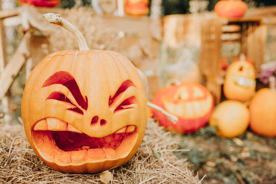 Ghost pumpkins on Halloween. ead Jack on an autumn background. Holiday outdoor decorations