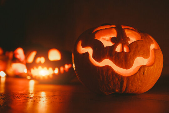 Ghost pumpkins on Halloween. ead Jack on Dark background. Holiday indoor decorations.