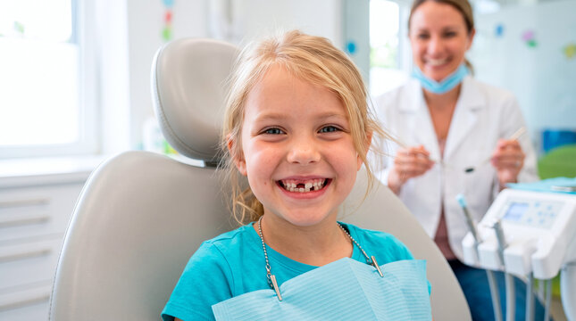 Happy young girl with missing baby teeth sitting in a dental chair for a routine checkup visit