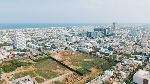 Chennai, Tamil Nadu, India - 16 September 2026: Aerial view of the Forum Mall construction site on OMR, showing cleared land, urban infrastructure, and the coastal city skyline.