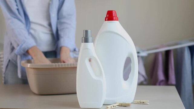Person hand washing clothes in soapy water, household laundry and fabric care concept