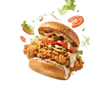 Crispy fried chicken sandwich with fresh lettuce and tomato slices floating, isolated on transparent background