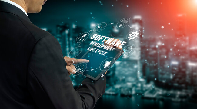 Businessman Using Tablet to Illustrate Software Development Life Cycle with Cityscape Background and Digital Icons of Technology and Innovation Quark.