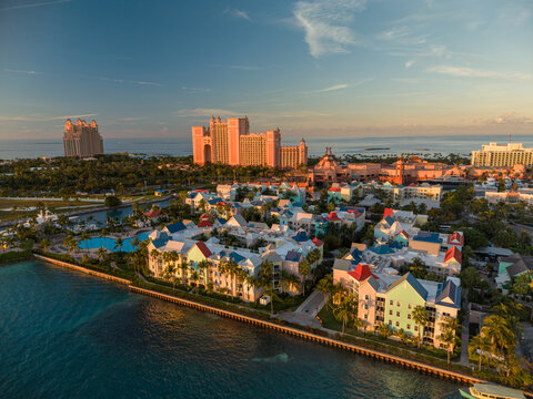 New Providence, The Bahamas - 03 January 2026: Aerial view of Paradise Island featuring the Atlantis resort complex and colorful waterfront buildings under a clear sky at sunset.