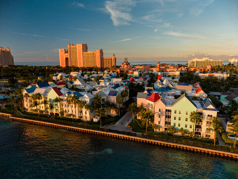 New Providence, The Bahamas - 03 January 2026: Aerial view of Paradise Island featuring the Atlantis resort complex, colorful waterfront buildings, and palm trees under golden hour light.