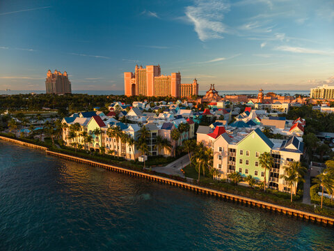 New Providence, The Bahamas - 03 January 2026: Aerial view of Paradise Island with colorful resort buildings, palm trees, and the Atlantis hotel under a clear blue sky at golden hour.