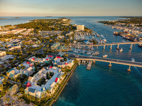 New Providence, The Bahamas - 03 January 2026: Aerial view of Paradise Island, showing the bridge, harbor with yachts, colorful resort buildings, and turquoise waters at golden hour.