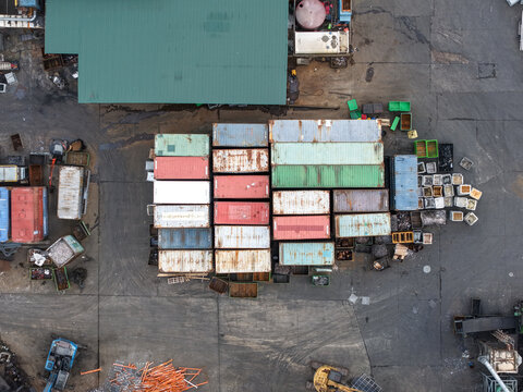 Ringwood, Victoria, Australia - 13 September 2026: Aerial view of Recycal facility featuring stacked shipping containers, industrial scrap materials, and heavy machinery in an outdoor yard.