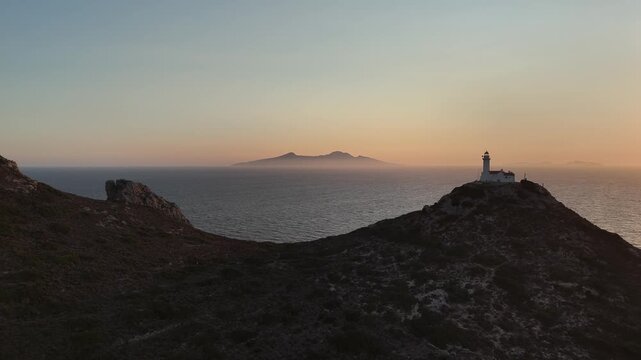 Dramatic Sunset Over Knidos Lighthouse and Foggy Sea Islands