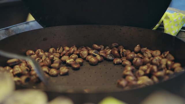 Roasted chestnuts preparation on stall at a traditional Christmas market in Cologne, Germany
