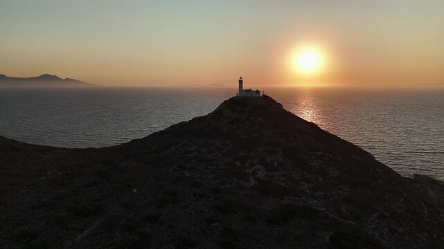Dramatic Sunset Over Knidos Lighthouse and Foggy Sea Islands