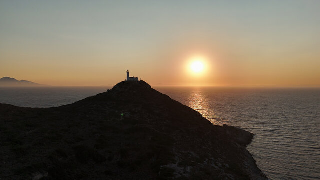 Dramatic Sunset Over Knidos Lighthouse and Foggy Sea Islands