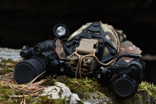Night vision monocular paired with thermal imaging device mounted on tactical camouflage cap outdoor forest gear close up view