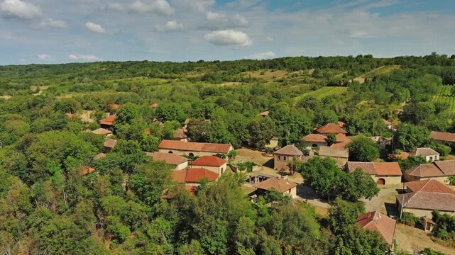 Aerial around view of old rustic vintage houses with wine cellars in Rogljevacke pivnice in Negotin region of Serbia, 4k