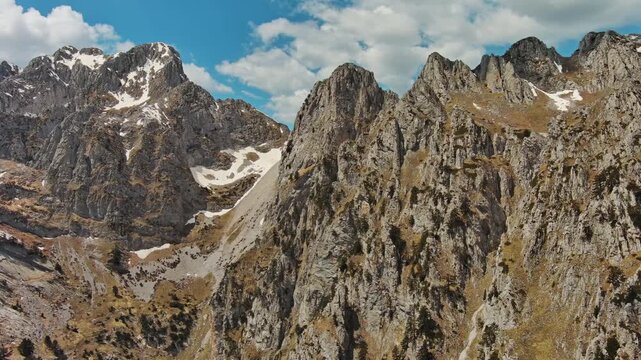 Aerial view of amazing rocky mountains in snow, Prokletie park, Montenegro and Albania, 4k