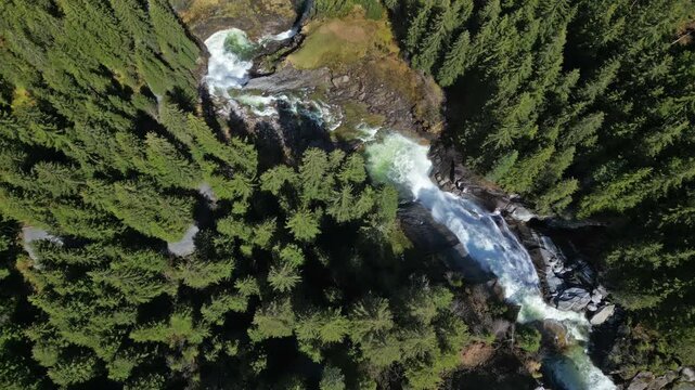 Aerial top view of Krimml Waterfalls in forest mountain. High Tauern National Park, Austrian Alps, Austria, 4k