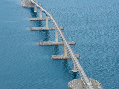 Aerial view of Lepsoy bridge spanning across the blue waters with concrete support pillars in Haram, More og Romsdal, Norway.