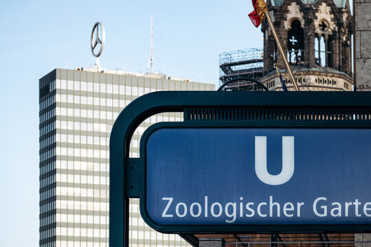 Berlin, Germany - April 23, 2026: Zoologischer Garten U Bahn station sign with the Mercedes Benz rooftop logo and Kaiser Wilhelm Memorial Church in Charlottenburg.