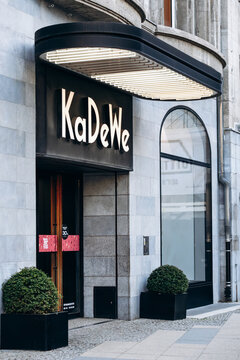 Berlin, Germany - April 23, 2026: Entrance and illuminated KaDeWe signage on the facade of the department store on Tauentzienstrasse.