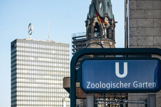 Berlin, Germany - April 23, 2026: Zoologischer Garten U Bahn station sign with the Mercedes Benz rooftop logo and Kaiser Wilhelm Memorial Church in Charlottenburg.