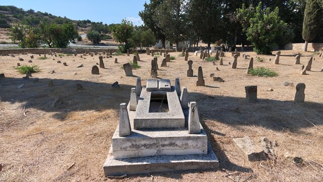 Tochni Turkish Cypriot Cemetery in Cyprus with historic stone graves and tombstones surrounding a prominent burial monument in a dry Mediterranean landscape
