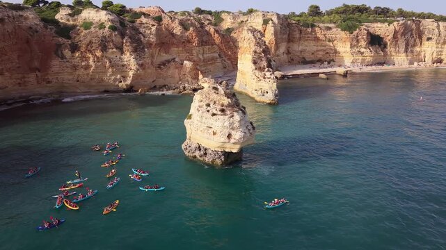 Tourists kayaking at marinha beach, portugal